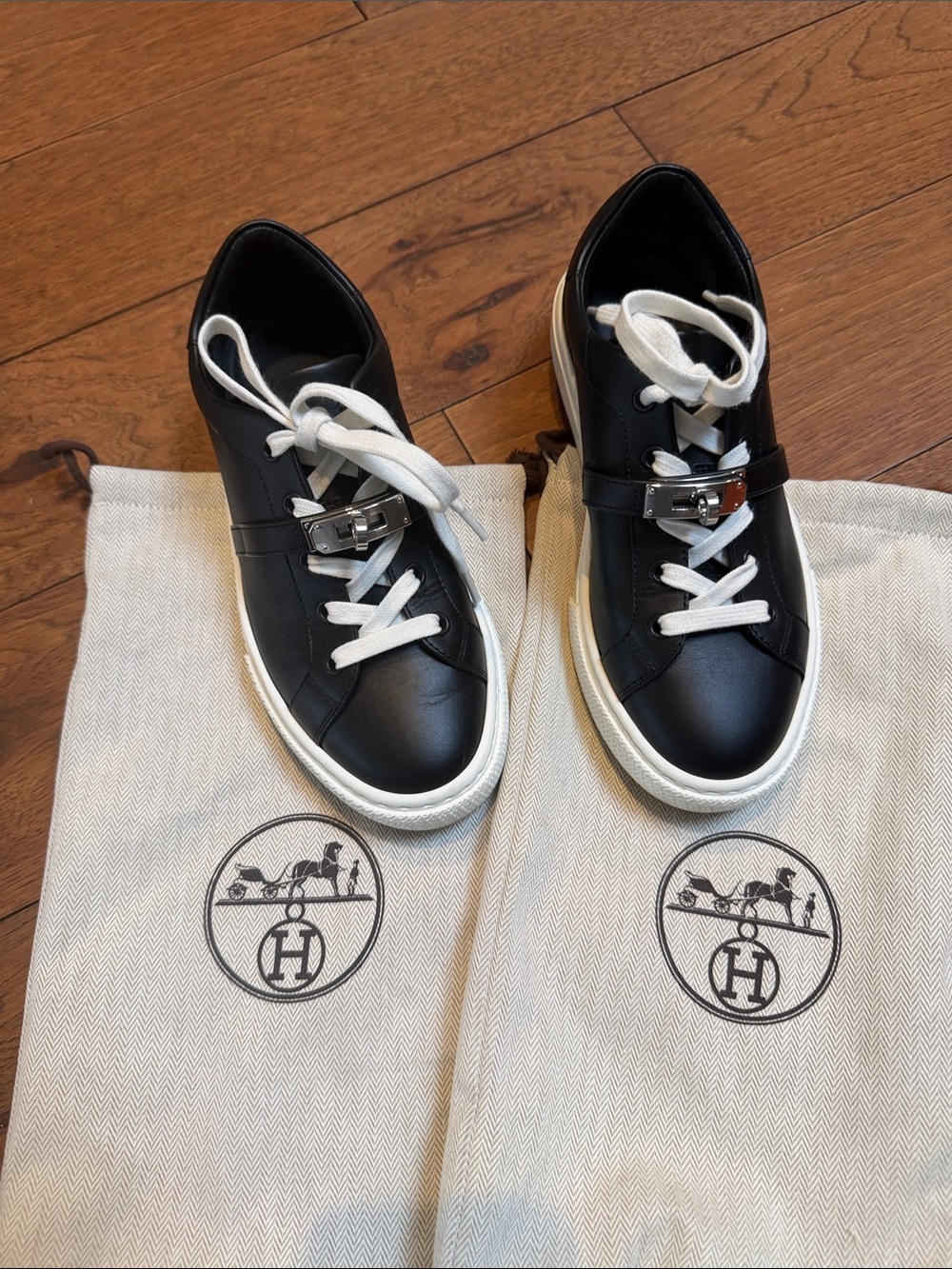 Authentic Hermès Black Leather Lock-Accent Sneakers with White Laces